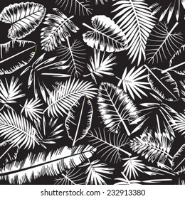 Seamless black and white tropical jungle pattern with jungle leaves and palm fronds. Vector illustration.