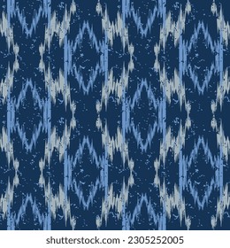 Seamless blue abstract ikat pattern in earthy color. Abstract background for textile design, wallpaper, surface textures, wrapping paper.