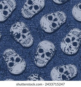 Seamless blue pattern with random scattered human skulls on denim fabric texture. Random composition. Grunge style