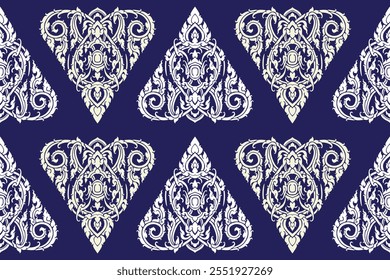 Seamless bold white colored traditional Thai art imagery triangle floral pattern in damask style motifs suitable for wallpaper, cloth, curtain, blanket, tile and fabric over navy colored background.