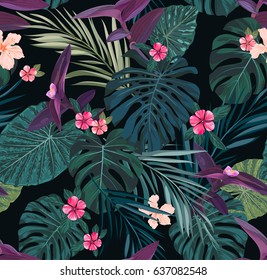 Seamless botanical exotic vector pattern with green palm leaves and hibiscus flowers on dark background.