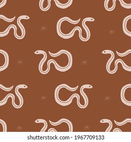 Seamless brown pattern with snakes and doodle stars. Wild West theme.  Simple childish  style perfect for textiles, baby shower fabrics, digital paper, fashion.