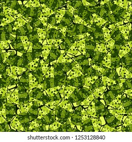 Seamless camouflage pattern. The motley-green leaves of maple lying on the background of the lattice with oblique crosshairs.