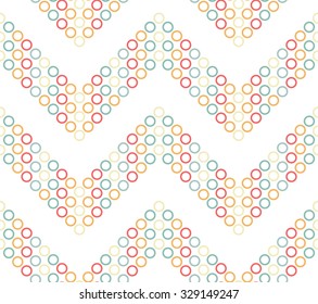 Seamless chevron pattern. Zigzag mosaic motif of colorful Circles and Dots. Abstract wavy Background. Vector Illustration.