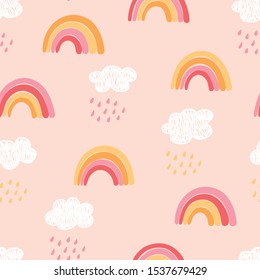 Seamless childish pattern with hand drawn pink rainbows, clouds and rain. Cute scandinavian kids texture for fabric, wrapping, wallpaper, clothes. Vector illustration