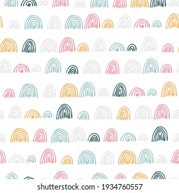 Seamless children's vector pattern with hand-made rainbows. Creative Scandinavian baby vector texture for fabric, wrap, textile, wallpaper, clothing. Vector rainbows seamless pattern.