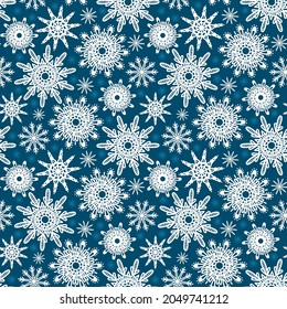 Seamless Christmas background of snowflakes on a blue background. Snowflake lace