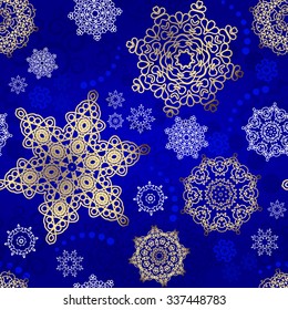 Seamless Christmas background. Vector  New Year pattern. Gold snowflakes on the blue backdrop. 