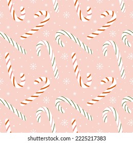 Seamless Christmas and New Year pattern. Coffee cane on a light pink background.