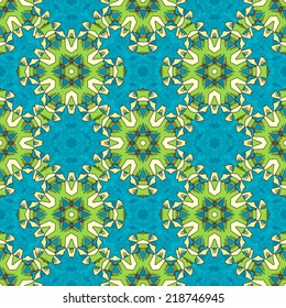 Seamless Christmas pattern. Blue, green and yellow background of ornate snowflakes.