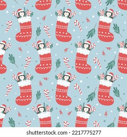 Seamless Christmas pattern with cute animals and seasonal elements. Festive background with Christmas sock and penguin