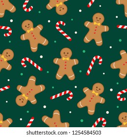 Seamless christmas pattern with gingerbread man and candy cane on dark background. Vector illustration 