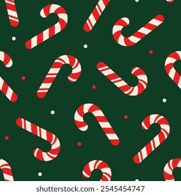 Seamless Christmas pattern with red and white candy cane on dark green background.