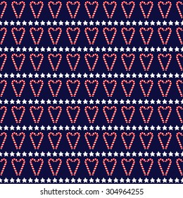 Seamless Christmas pattern with stars and candy canes. Happy New Year and Merry Xmas background texture. Vector design for winter holidays on dark blue background. Candy hearts illustration. 