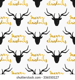 Seamless Christmas pattern with stylized reindeer heads in black with gold hand lettered Merry Christmas message on white background.