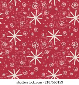 Seamless Christmas snowflake pattern. Seamless vector white snowflakes of different sizes on red background for fabric or wrapping paper print. 