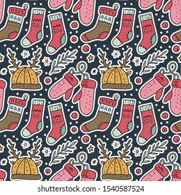 Seamless Christmas winter vector pattern. Hat with deer horns, socks and gloves in hand drawn doodle style.