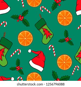 Seamless Christmas/New Year pattern with hand drawn holiday attributes: santa hat, candy, mistletoe, christmas sock, oranges on blue background.
