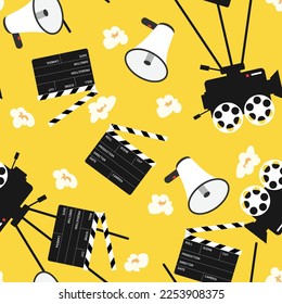 Seamless cinema production pattern on yellow background. With megaphone, speaking-trumpet, bullhorn, camera, clapperboard and popcorn.