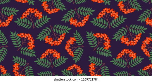 Seamless colorful autumn pattern with rowan berries and green leaves on a dark background. Floral rowan vector illustration for print.