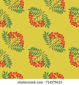 Seamless colorful autumn pattern with rowan and green leaves on a yellow background. Floral rowan illustration for print.