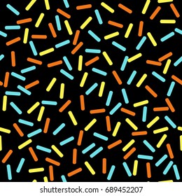 Seamless colorful dark vector abstract pattern. Cute funny confetti sprinkle strokes in yellow, orange and light blue on black background.
