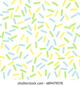 Seamless colorful light vector abstract pattern. Cute funny confetti sprinkle strokes in yellow, green and light blue on white background.