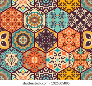 Seamless colorful patchwork tile with Islam, Arabic, Indian, Ottoman motifs. Majolica pottery tile. Portuguese and Spain decor. Azulejo. Ceramic tile in talavera style. Boho pattern