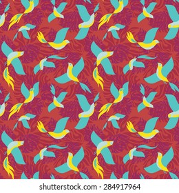 Seamless colorful pattern with tropical birds and leaves.