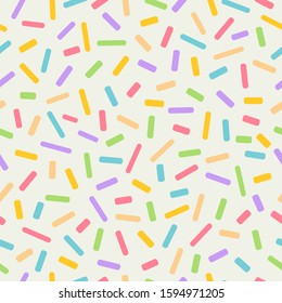 Seamless colourful sprinkles repeat pattern on a light background, birthday celebration theme