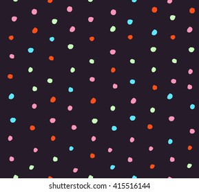 Seamless confetti background with hand drawn different colored round shaped confetti pieces