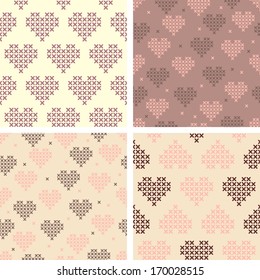 Seamless cross stitched pattern with red hearts, white background