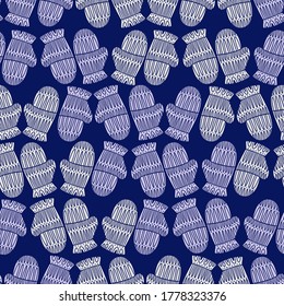 Seamless cute vector design of knitted mittens in pastel cold tones on blue