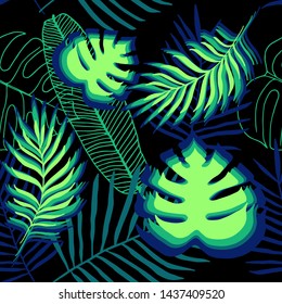 Seamless dark pattern of tropical palm, banana and monstera leaves on black background.