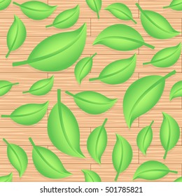 Seamless decorative template texture with green leaves on wooden background.