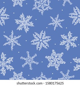 Seamless design of white snowflakes, snowfall on a blue background.  Snow vector illustration design for Christmas and New Year print textile paper.
