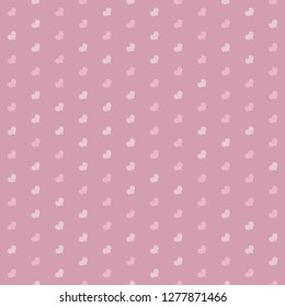 Seamless diagonal hearts pattern in shades of pink.
