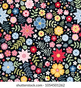Seamless ditsy floral pattern with bright colorful flowers and leaves on black background in naive folk style. Summer template for fashion prints in vector.