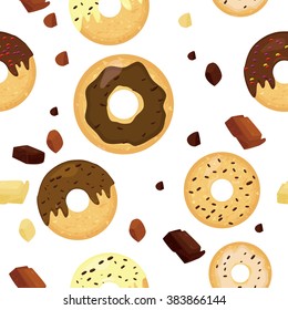 Seamless donuts pattern.  Chocolate donuts and pieces of chocolate pattern.