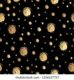 Seamless doodle design with gold painted dots on a black background. Vector illustration.