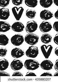 Seamless dot and heart pattern.Hand painted circles with rough edges. Dry brush ink illustration. Abstract textured background with round brush strokes.Monochrome hand drawn texture.Stylish polka dot