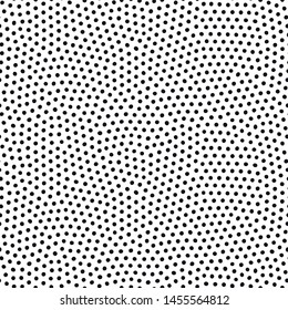 Seamless dot pattern with randomly disposed spots. Dotted background. Black and white vector trendy texture.