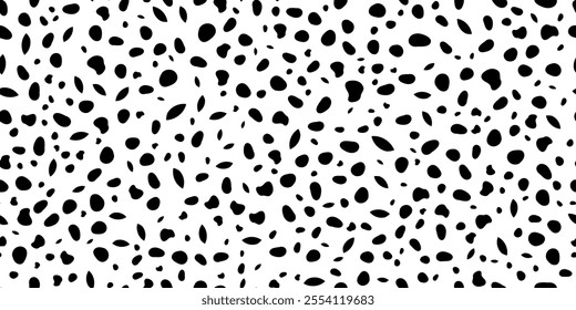 Seamless dotted pattern. Black specks and spots on a white background. Texture is grainy and large