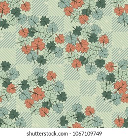 Seamless editable texture. Groups of colored leaves sketched on a diagonal-chess surface.