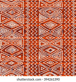 Seamless ethnic geometric pattern.  Black, orange and white graphics, diamonds, triangles and zigzags, folk motives, hand drawn background.