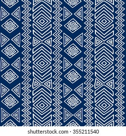 Seamless ethnic geometric pattern. Blue and white graphics, diamonds, triangles and zigzags on a white background, folk motives.