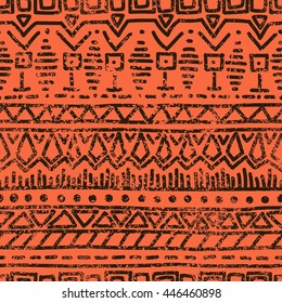 Seamless ethnic grunge background. Geometric pattern. Handmade. Tribal motifs. Black elements on an orange background in grunge style. Vintage vector illustration.