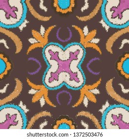 Seamless ethnic ikat floral pattern. mixed color tile. brown background