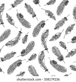 Seamless ethnic pattern with black feathers on white background. Vector illustration.