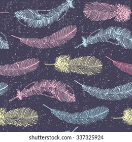 Seamless ethnic pattern with colored feathers on purple background. Vector illustration.